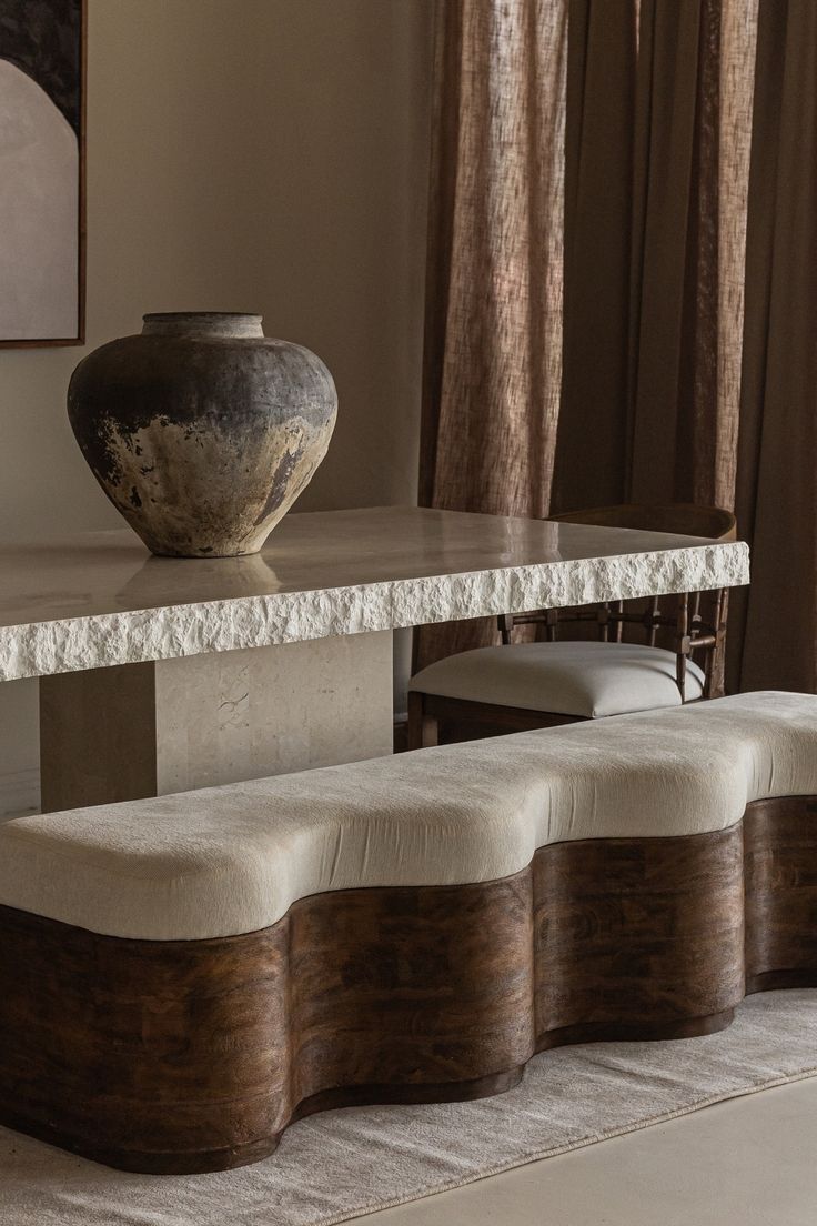 The_gentle_curves_of_the_Triana_bench_complement_the_raw_beauty_of_the_handcrafted_La_Via_dining_table__a_perfect_pairing_of_form_and_texture_.jpg